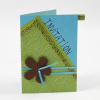 A Greeting Card with netted Fabric and a Flower on Satin Ribbon
