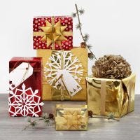 Gift Wrapping with metallic Wrapping Paper and shiny Decorations