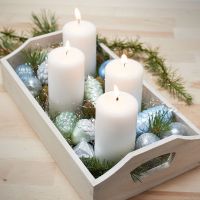 A Tray with four Candles and painted Glass and Terracotta Christmas Baubles