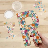 A Papier-mâché Letter decorated with Sequins and Sticky Base