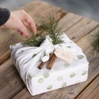 Gift wrapping with a tea towel decorated with a stamped design